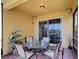 Enjoy this outdoor screened lanai, with a table, chairs, and a sliding door leading to inside the home at 2502 Palm Tree Dr, Poinciana, FL 34759