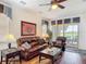 Relaxing living room offers a plush leather sofa, natural light, and stylish decor for a welcoming atmosphere at 2502 Palm Tree Dr, Poinciana, FL 34759