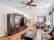 Spacious living room featuring hardwood floors, decorative accents, and an open layout leading into the dining area at 2502 Palm Tree Dr, Poinciana, FL 34759