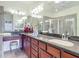 Well-lit bathroom featuring dual vanities, a large mirror, and a glass-enclosed shower for a spa-like experience at 2502 Palm Tree Dr, Poinciana, FL 34759