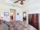 Serene bedroom with tray ceilings offering an ensuite bathroom, hardwood floors, and neutral color palette at 2502 Palm Tree Dr, Poinciana, FL 34759