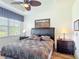 Comfortable bedroom featuring a king-size bed, tray ceiling, and a large window with natural light at 2502 Palm Tree Dr, Poinciana, FL 34759