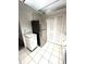 Bright kitchen with stainless steel refrigerator and white cabinets, optimizing space and storage at 2538 Citrus Club Ln # 105, Orlando, FL 32839
