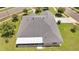 Bird's eye view of a single-story house with gray roof shingles and a screened-in patio at 2801 Palmyra Ct, St Cloud, FL 34772