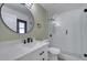 Bathroom featuring a modern vanity, a round mirror, and a shower with glass doors at 2801 Palmyra Ct, St Cloud, FL 34772