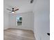 Cozy bedroom with a ceiling fan, hardwood flooring, and a bright window at 2801 Palmyra Ct, St Cloud, FL 34772