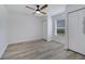 Bright bedroom with ceiling fan, window, hardwood flooring, and closets at 2801 Palmyra Ct, St Cloud, FL 34772