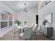 Bright dining room featuring modern chandelier, and large window for natural light at 2801 Palmyra Ct, St Cloud, FL 34772