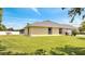 Side view of home featuring lush green lawn, screened-in patio, and neutral-colored siding at 2801 Palmyra Ct, St Cloud, FL 34772