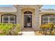 Inviting front entrance with stone pillars, arched entryway, and well-manicured landscaping at 2801 Palmyra Ct, St Cloud, FL 34772