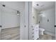 Hallway between a bedroom and a bathroom, both with hardwood flooring at 2801 Palmyra Ct, St Cloud, FL 34772