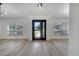 Bright and airy living room with wood-look flooring and natural light from the front door at 2801 Palmyra Ct, St Cloud, FL 34772