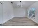 Bright living room features modern lighting fixtures, large windows, and wood-look flooring at 2801 Palmyra Ct, St Cloud, FL 34772
