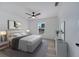 Nicely staged primary bedroom with hardwood flooring, ceiling fan, and a cozy rug at 2801 Palmyra Ct, St Cloud, FL 34772