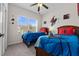 Charming bedroom with two beds and a window overlooking the yard, ideal for a comfortable and stylish rest at 2835 Oakwater Dr # 2835, Kissimmee, FL 34747