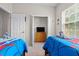 Comfortable bedroom with two beds, closet view, and natural light, ideal for relaxation and rest at 2835 Oakwater Dr # 2835, Kissimmee, FL 34747