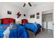 This bedroom features two beds, ceiling fan, and adjacent laundry room, perfect for convenient living at 2835 Oakwater Dr # 2835, Kissimmee, FL 34747