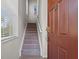 Entryway featuring a carpeted staircase leading to the upper level of the home at 2835 Oakwater Dr # 2835, Kissimmee, FL 34747