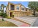 Inviting townhome exterior with garages, complemented by well-maintained landscaping at 2835 Oakwater Dr # 2835, Kissimmee, FL 34747