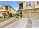 Charming exterior of townhomes with individual garages and driveways at 2835 Oakwater Dr # 2835, Kissimmee, FL 34747
