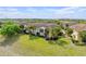 Back exterior view of townhomes with lush lawn and tropical landscaping, highlighting community living at 2835 Oakwater Dr # 2835, Kissimmee, FL 34747