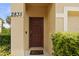 Close-up of the front door of home 2835 with plants and a 