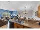 Open concept living area featuring a breakfast bar connecting to the kitchen, ideal for modern living at 2835 Oakwater Dr # 2835, Kissimmee, FL 34747