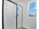 Bright bathroom featuring a sleek shower with glass doors, window, and white tile at 2943 Gavin Sky Dr, Kissimmee, FL 34744
