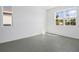 Empty bedroom with neutral walls and tile floors and a view of the front yard at 2943 Gavin Sky Dr, Kissimmee, FL 34744