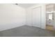 Empty bedroom featuring gray carpet and an ensuite bathroom at 2943 Gavin Sky Dr, Kissimmee, FL 34744