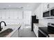 Bright kitchen with white cabinets, stainless steel appliances, and an island and stone countertops at 2943 Gavin Sky Dr, Kissimmee, FL 34744