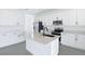 Bright kitchen features white cabinets, stainless steel appliances, an island and stone countertops at 2943 Gavin Sky Dr, Kissimmee, FL 34744