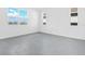 Empty room with gray tile flooring and a view of the neighborhood pond at 2943 Gavin Sky Dr, Kissimmee, FL 34744