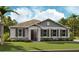 Charming one-story home with a well-manicured lawn, stone accents, a covered entryway, and tasteful landscaping at 2955 Gavin Sky Dr, Kissimmee, FL 34744