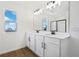 Modern bathroom with double sink vanity, black hardware, and a view of the lake at 2961 Gavin Sky Dr, Kissimmee, FL 34744