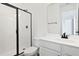 Modern bathroom with sleek fixtures, walk-in shower with glass door, and white vanity at 2961 Gavin Sky Dr, Kissimmee, FL 34744