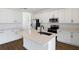 Modern kitchen with white cabinetry, stainless steel appliances, and an island with a sink at 2961 Gavin Sky Dr, Kissimmee, FL 34744