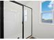 Clean, modern bathroom features a shower with a glass door and an outside view at 2961 Gavin Sky Dr, Kissimmee, FL 34744