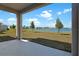 View of lake from the covered back patio with a concrete floor and supporting columns at 2967 Gavin Sky Dr, Kissimmee, FL 34744