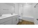 Bright bathroom featuring double sinks, white cabinets, and a shower-tub combination with white tile at 2967 Gavin Sky Dr, Kissimmee, FL 34744