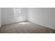 Empty bedroom features neutral carpet, a single window, and white walls at 2967 Gavin Sky Dr, Kissimmee, FL 34744