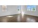 Bright bedroom featuring wood-look tile flooring and large windows offering plenty of natural light and ventilation at 2967 Gavin Sky Dr, Kissimmee, FL 34744