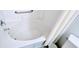 Close-up of a clean, white bathtub with tile surround and shower fixtures, featuring grab bar at 300 Falling Water Dr, Kissimmee, FL 34759