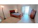 Bedroom featuring a bed, dresser, and glass doors providing access to the outside at 300 Falling Water Dr, Kissimmee, FL 34759