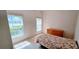 Bright bedroom with tile flooring, windows, and a comfortable bed with floral bedding at 300 Falling Water Dr, Kissimmee, FL 34759