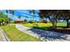 Picturesque view of the community with a winding walkway, bench, pool, and lake creating an inviting outdoor space at 300 Falling Water Dr, Kissimmee, FL 34759