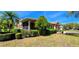 Well-maintained lawn, professional landscaping, and charming single-story home with a screened-in porch at 300 Falling Water Dr, Kissimmee, FL 34759