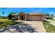 Charming single-story home with a well-maintained lawn and a spacious two-car garage at 300 Falling Water Dr, Kissimmee, FL 34759
