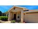 Close-up of the front entrance and two-car garage, showcasing the home's neutral color palette at 300 Falling Water Dr, Kissimmee, FL 34759