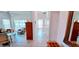 Long tiled hallway leading to a living room with view to bathroom at 300 Falling Water Dr, Kissimmee, FL 34759
